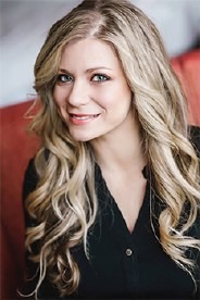 Portrait of Celeste Grande, CPA, smiling, with long blonde hair and a dark blouse